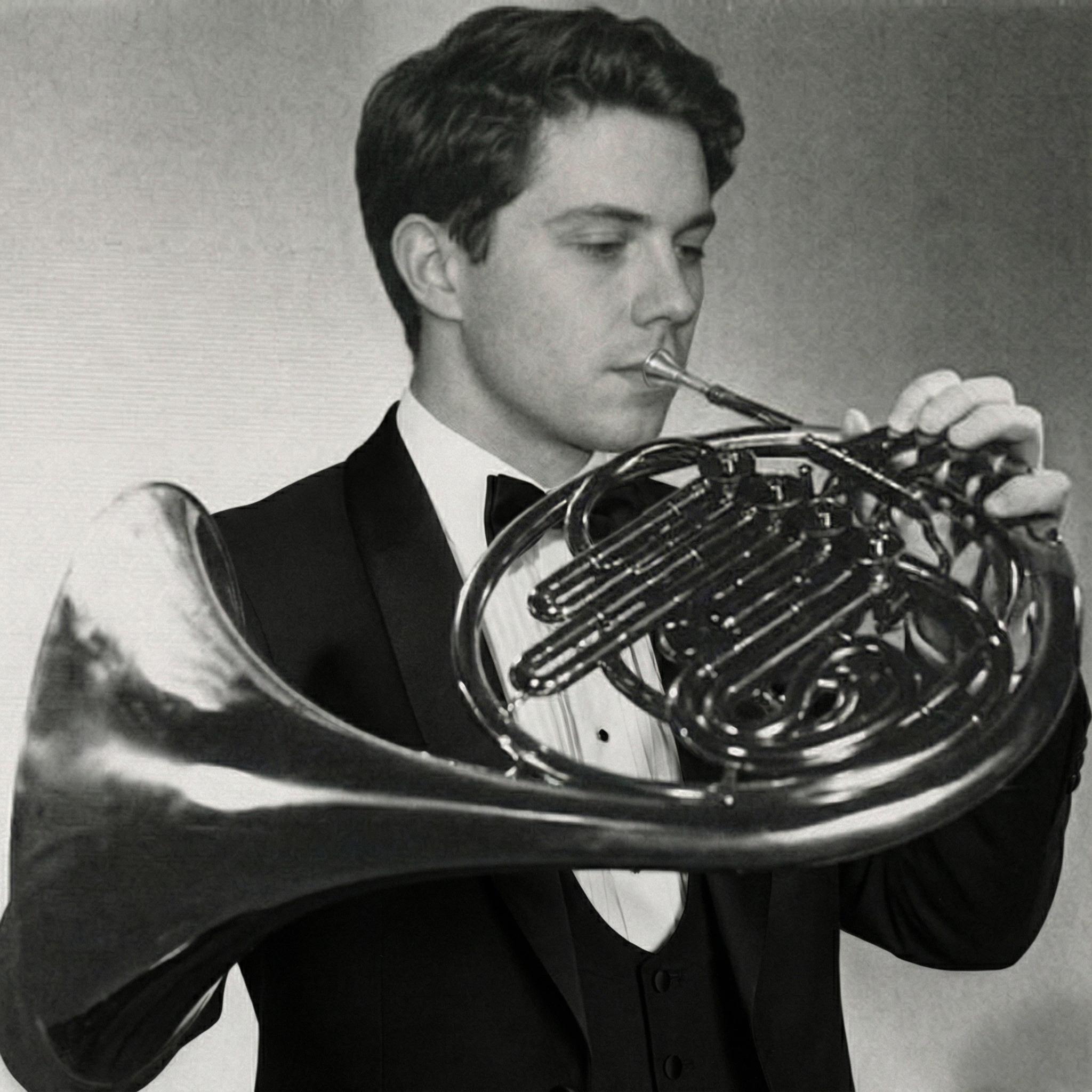 Black and white portrait of Trevor Nuckols playing in a tuxedo