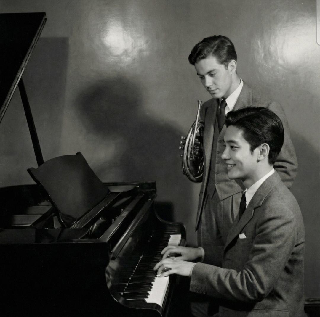 Black and white photo of Trevor with pianist and French horn