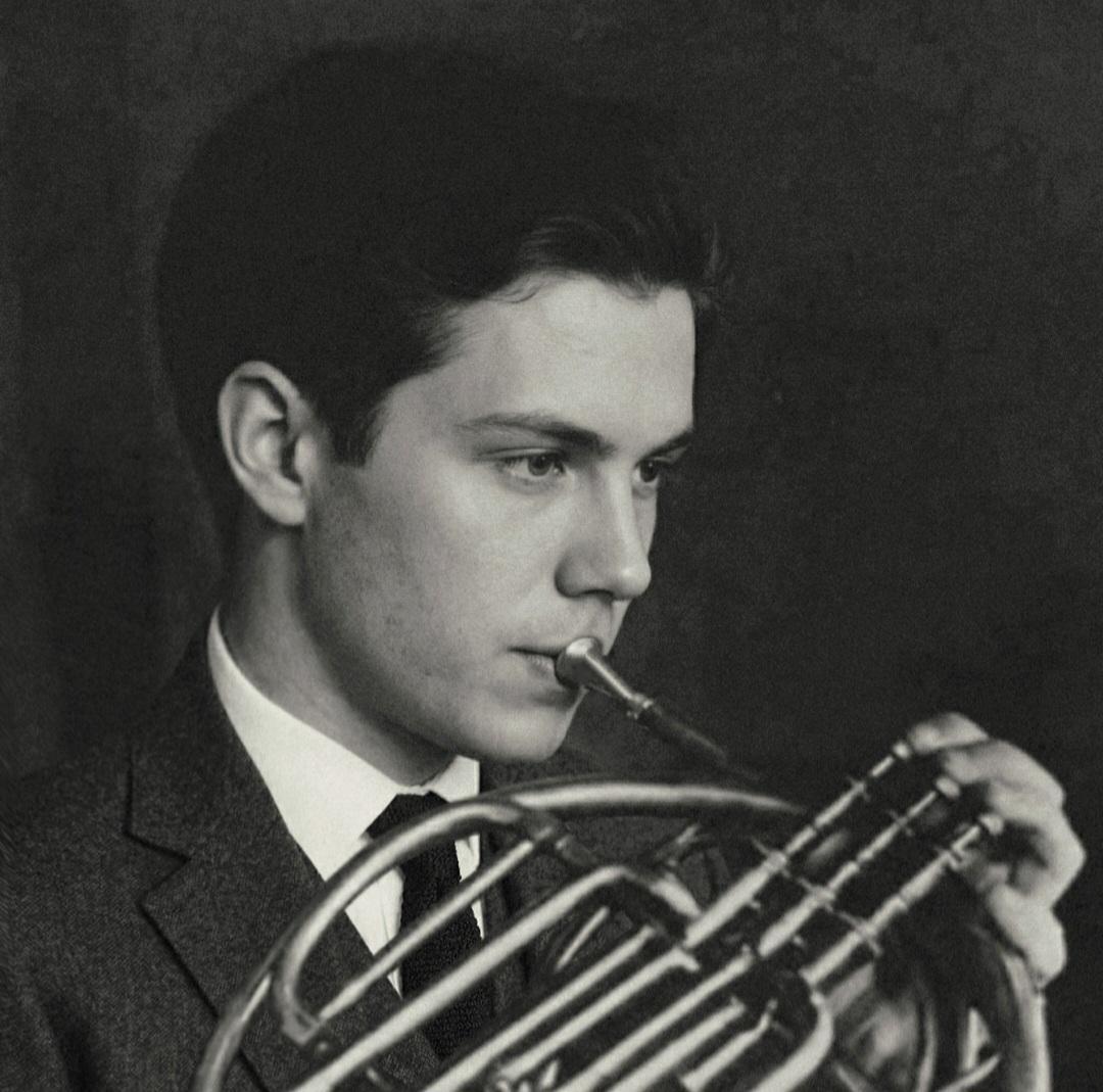 Black and white profile of Trevor playing the horn